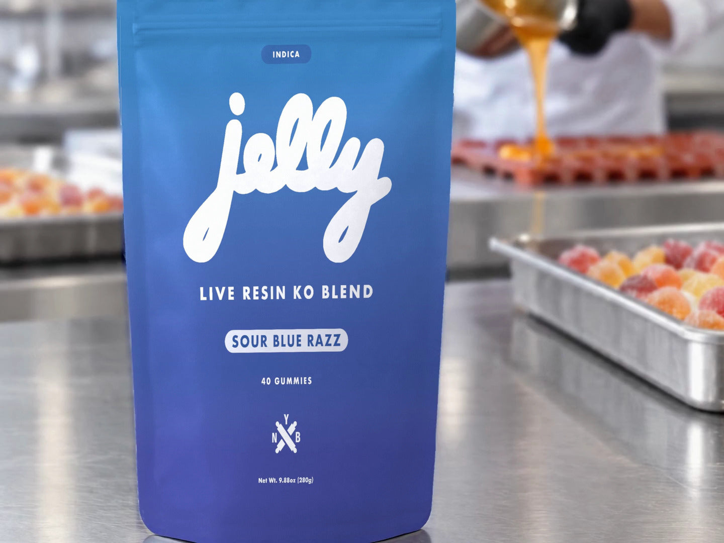 A Jelly Sour Blue Razz pouch on a steel bench in a confectionery kitchen
